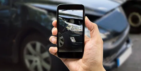 Man capturing evidence after a car accident Man capturing evidence after a car accident