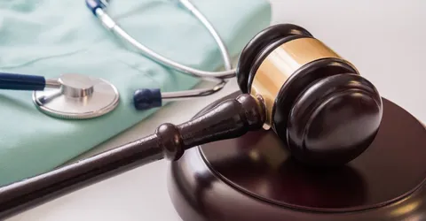 Gavel and stethoscope in background